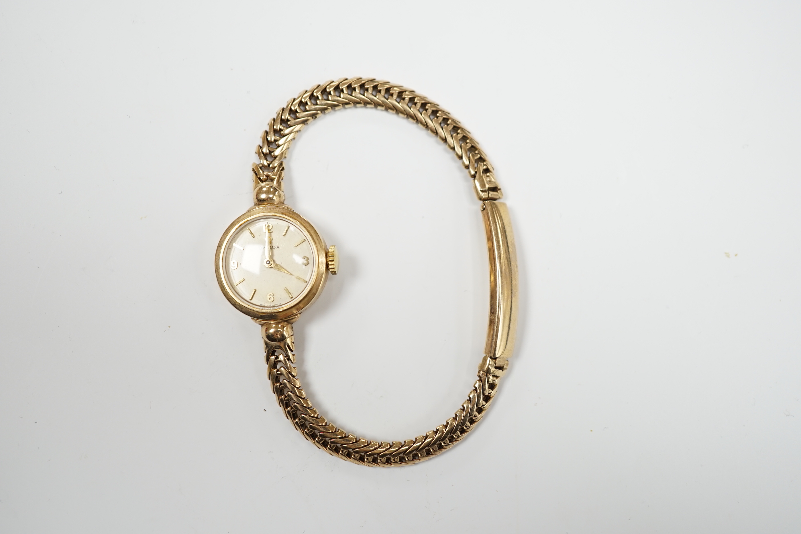 A lady's 9ct gold Omega manual wind wrist watch, on an associated 9ct gold bracelet, gross weight 17.6 grams, with Omega box.